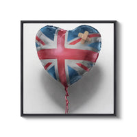 a heart shaped balloon with a cross on it