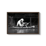 a black and white photo of a man in a boat