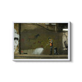 a man spray painting a wall with graffiti