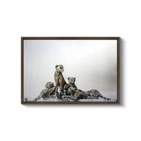 a painting of two giraffes sitting on top of a hill