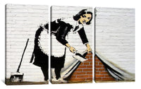 a painting of a woman with a broom on a brick wall