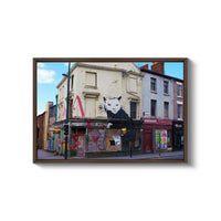 a painting of a cat on the side of a building