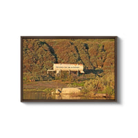 a picture of a farm with a water source in the foreground
