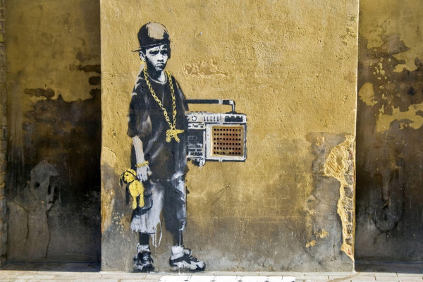 a painting of a man with a boombox on the side of a building