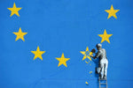a man on a ladder painting a wall with yellow stars