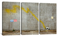 a cow standing in a parking lot next to a wall