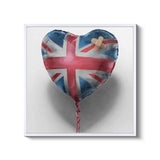 a heart shaped balloon with a cross on it