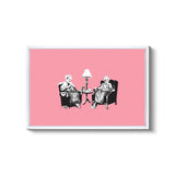 a couple of people sitting in chairs next to a lamp