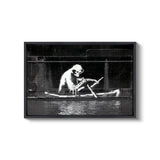 a black and white photo of a man in a boat