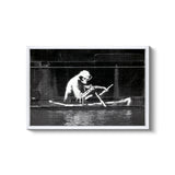 a black and white photo of a man in a boat