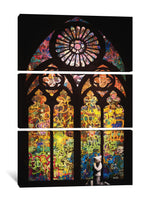 a cat sitting in front of a stained glass window