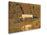 a large white tank sitting on top of a lush green hillside