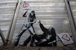 a mural of a man holding a protest sign