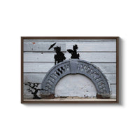 a picture of a cement arch with a bird flying over it