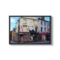 a painting of a cat on the side of a building