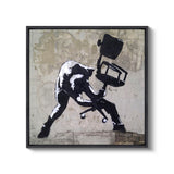 a black and white picture of a man sitting on a chair