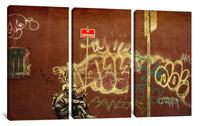 a wall with graffiti on it and a street sign