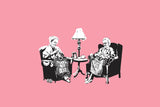 a couple of people sitting in chairs next to a lamp