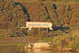 a large tank sitting on top of a lush green hillside