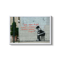 a man sitting on a chair in front of a wall