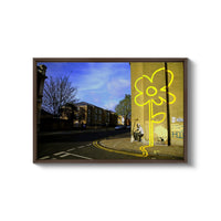 a picture of a yellow flower on the side of a building