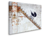 a brick wall with a painting of a baby carriage on it
