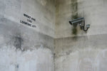 a security camera mounted to the side of a wall