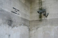a security camera mounted to the side of a wall