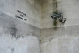 a security camera mounted to the side of a wall