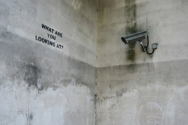 a security camera mounted to the side of a wall