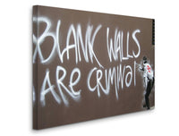 a man standing next to a wall with graffiti on it