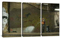 a man spray painting on the side of a building